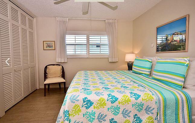 150 North Ocean Boulevard, Unit S26 Delray Beach, FL 33483 - Photo 6 of 8 a bedroom with a bed and a chair