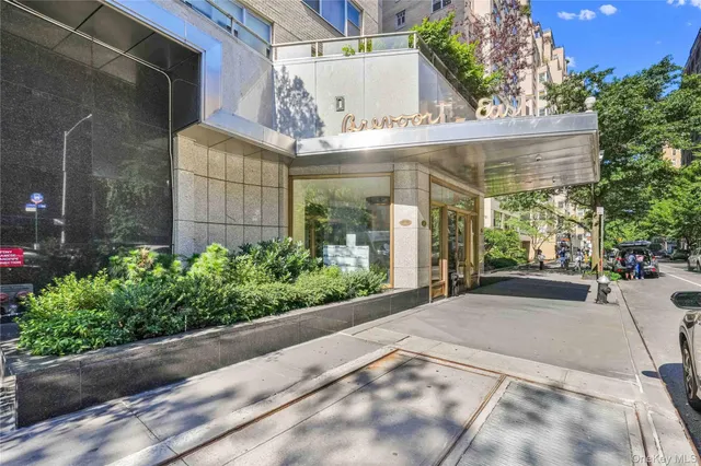 a living room with furniture and large windows
