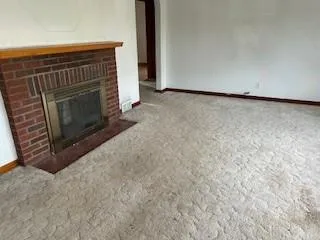 a view of empty room with a fireplace