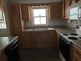 a kitchen with a sink stove top oven and cabinets