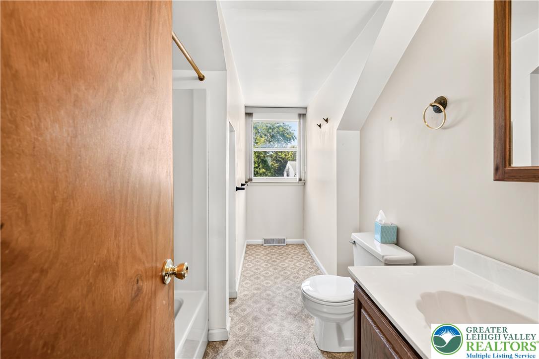 168 Springhouse Road Allentown, PA 18104 - Photo 31 of 49 A compact and functional bathroom features a single window providing natural light and patterned flooring.