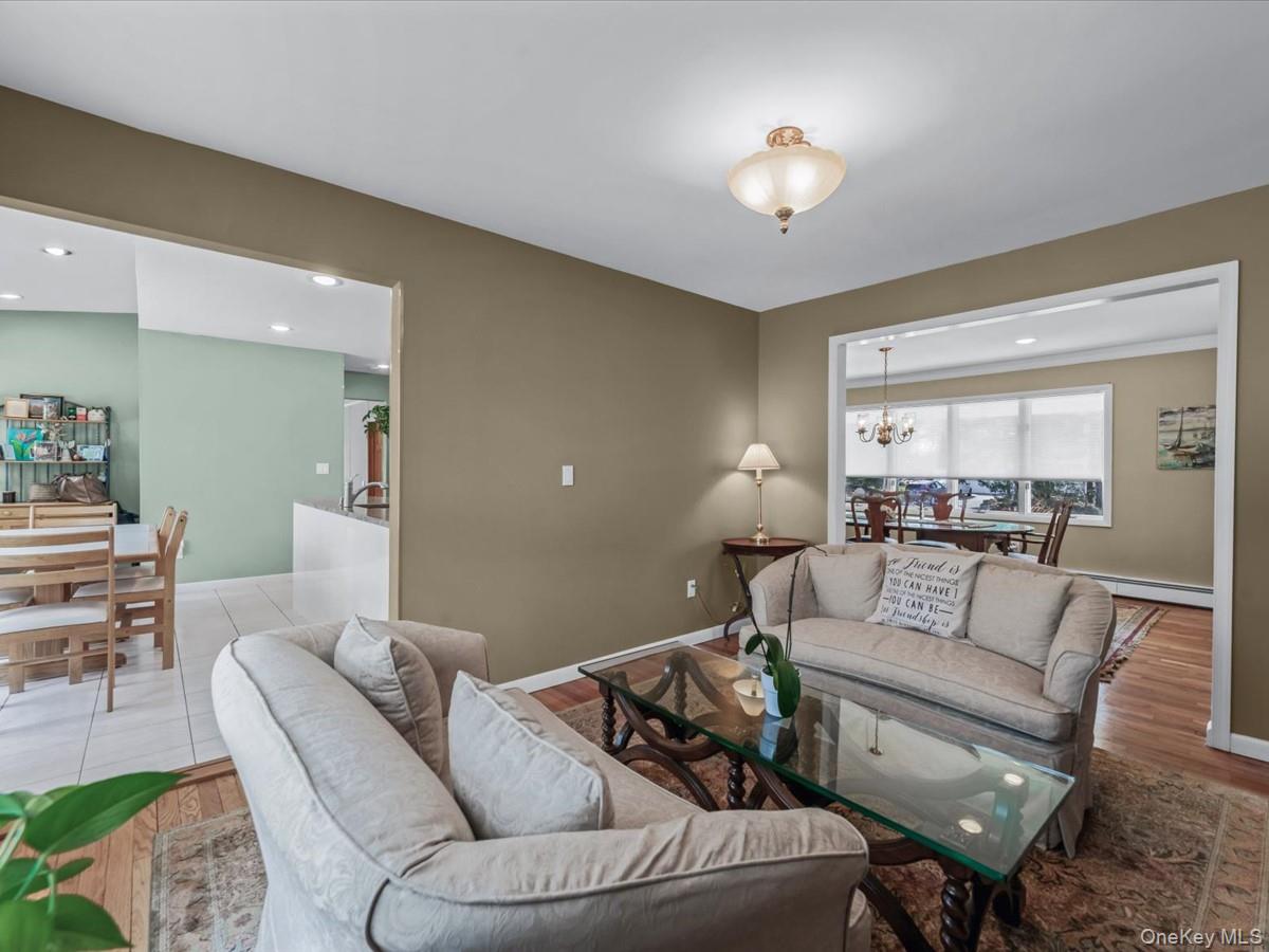 29 Sun Hill Road Nesconset, NY 11767 - Photo 11 of 32 a living room with furniture and a chandelier