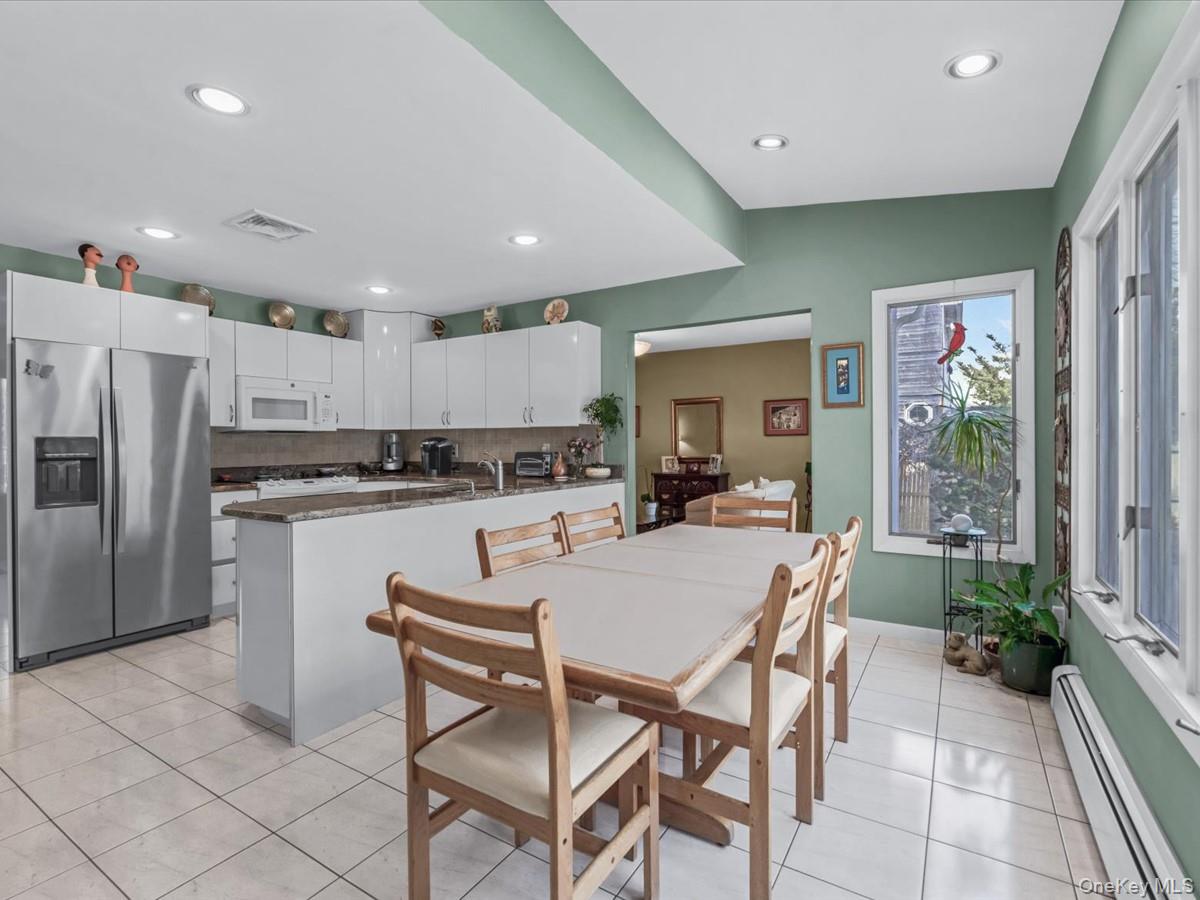 29 Sun Hill Road Nesconset, NY 11767 - Photo 13 of 32 a kitchen with kitchen island a table and chairs in it