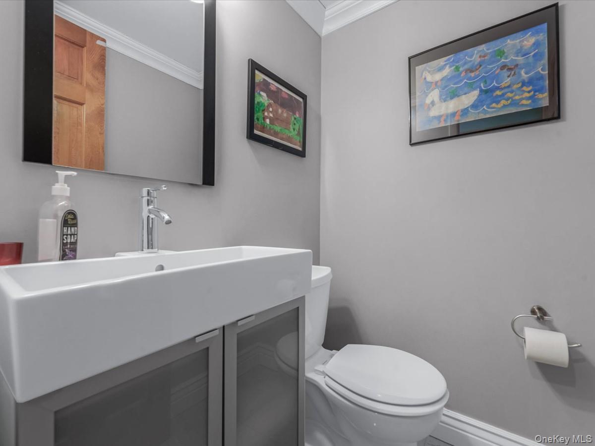 29 Sun Hill Road Nesconset, NY 11767 - Photo 14 of 32 a bathroom with a toilet a sink and mirror