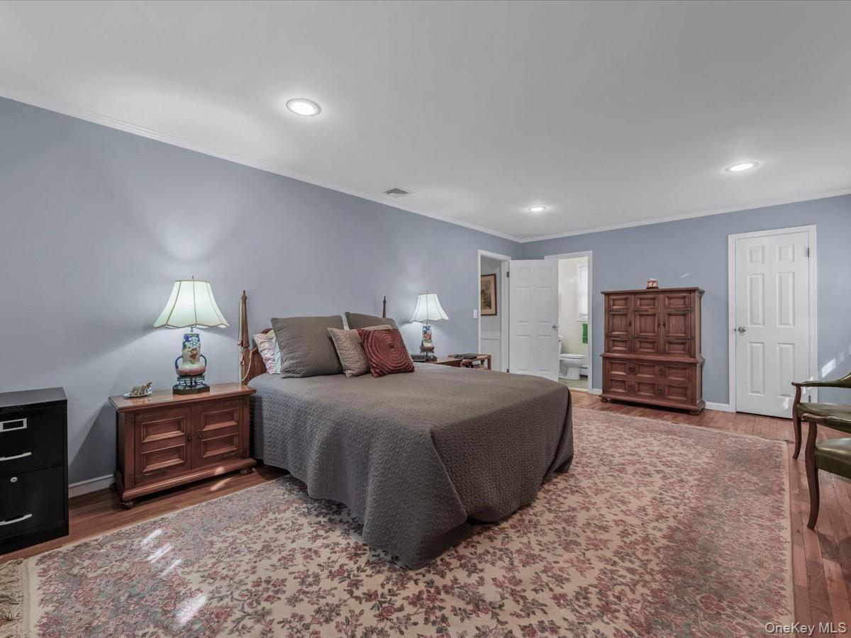 29 Sun Hill Road Nesconset, NY 11767 - Photo 18 of 32 a spacious bedroom with a bed a dresser and cabinets