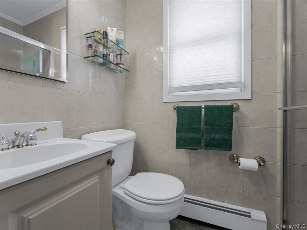 29 Sun Hill Road Nesconset, NY 11767 - Photo 19 of 32 a bathroom with a sink a toilet and mirror