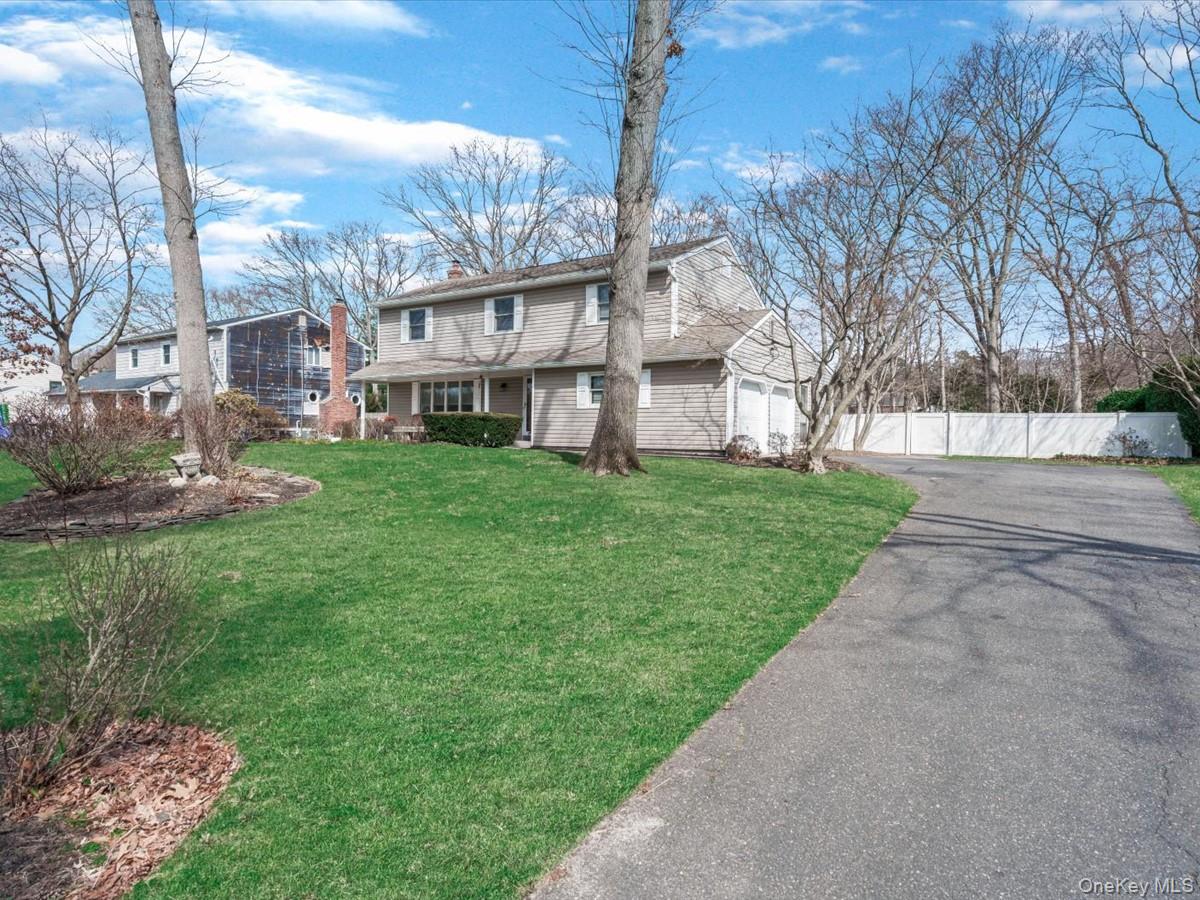 29 Sun Hill Road Nesconset, NY 11767 - Photo 2 of 32 a view of a white house next to a yard with big trees