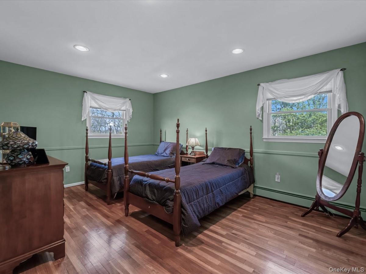 29 Sun Hill Road Nesconset, NY 11767 - Photo 22 of 32 a bedroom with a bed and wooden floor