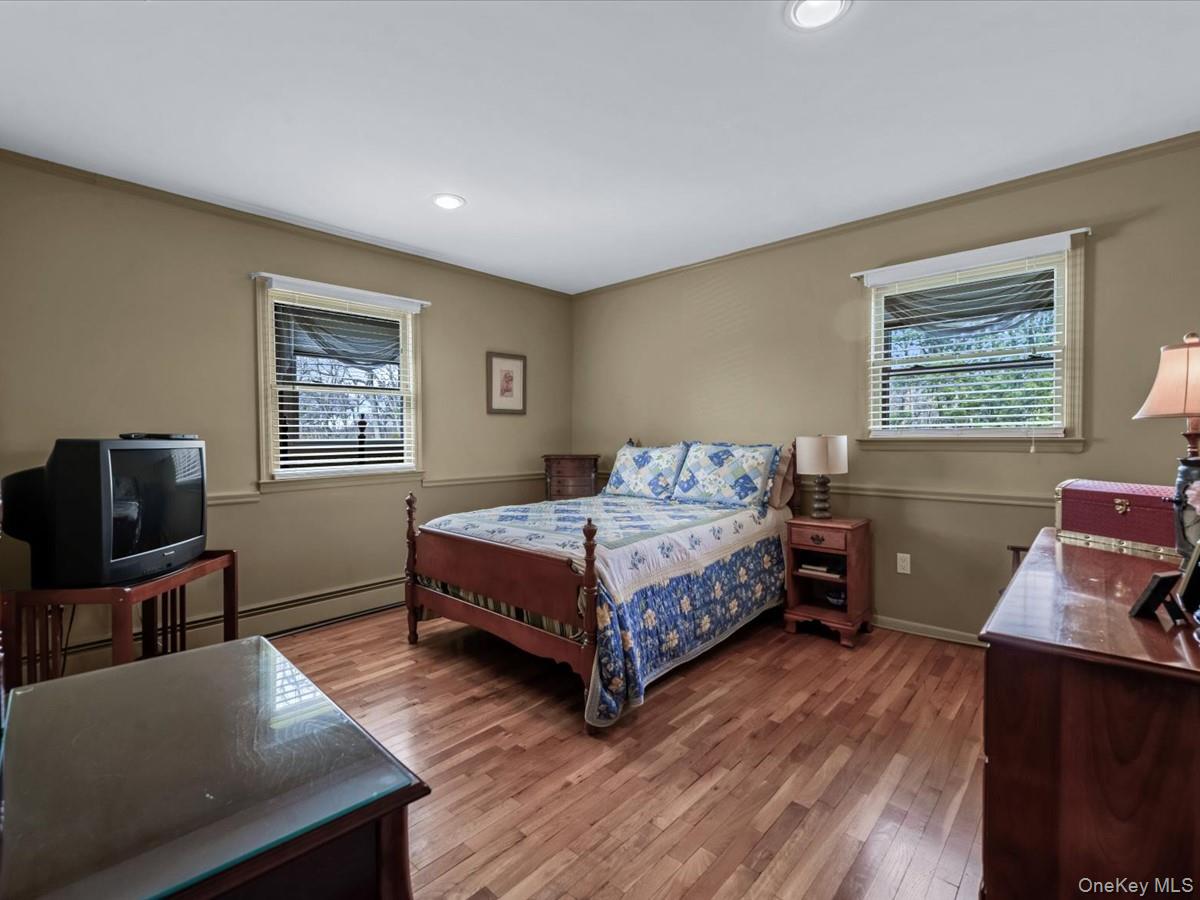 29 Sun Hill Road Nesconset, NY 11767 - Photo 23 of 32 a bedroom with a bed furniture and a flat screen tv