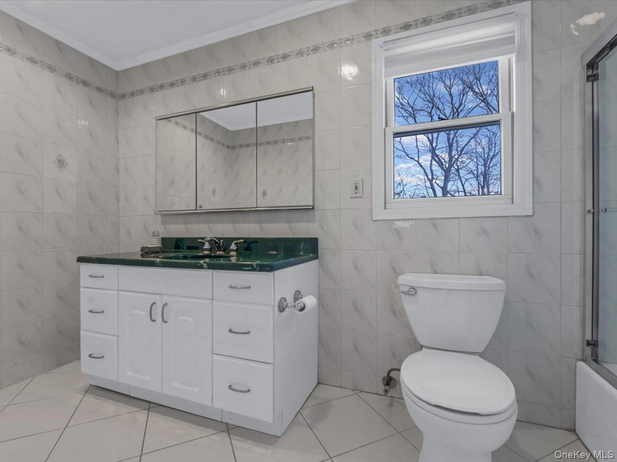 29 Sun Hill Road Nesconset, NY 11767 - Photo 24 of 32 a bathroom with a toilet a sink and a mirror