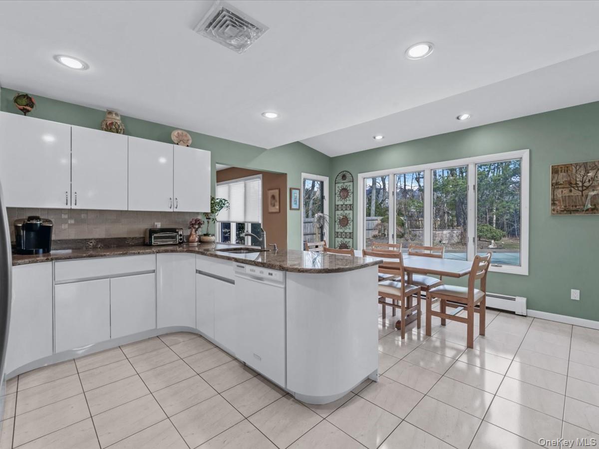29 Sun Hill Road Nesconset, NY 11767 - Photo 3 of 32 a kitchen with cabinets and chairs