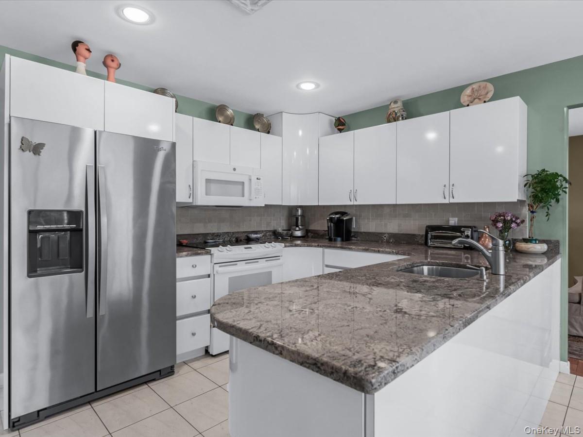 29 Sun Hill Road Nesconset, NY 11767 - Photo 4 of 32 a kitchen with stainless steel appliances granite countertop a refrigerator sink and cabinets
