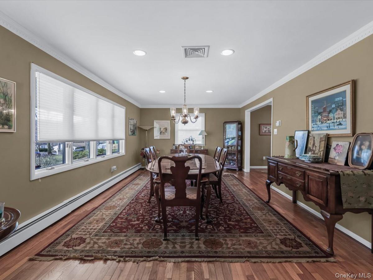 29 Sun Hill Road Nesconset, NY 11767 - Photo 7 of 32 a dining room with furniture a rug and a large window