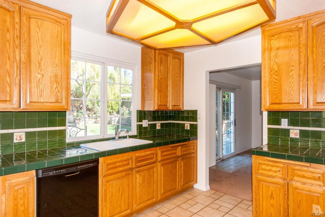 2753 Fitzgerald Road Simi Valley, CA 93065 - Photo 4 of 12 a kitchen with granite countertop a sink and a refrigerator