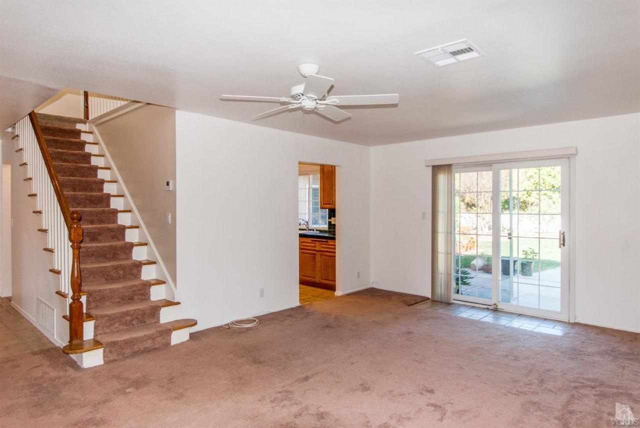 2753 Fitzgerald Road Simi Valley, CA 93065 - Photo 6 of 12 a view of an empty room with stairs and chandelier fan