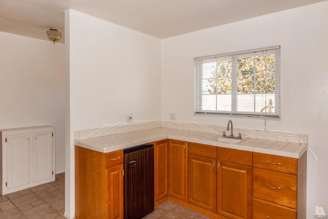 2753 Fitzgerald Road Simi Valley, CA 93065 - Photo 9 of 12 a kitchen with a sink cabinets and a window