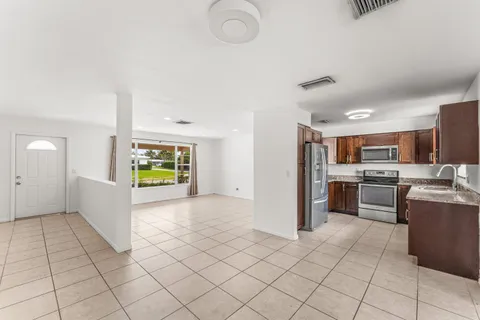 a view of kitchen with windows and refrigerator