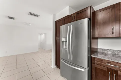 a kitchen with metallic refrigerator freezer and a dishwasher