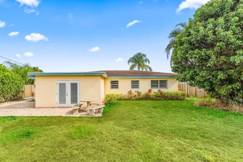 a front view of house with yard and outdoor seating