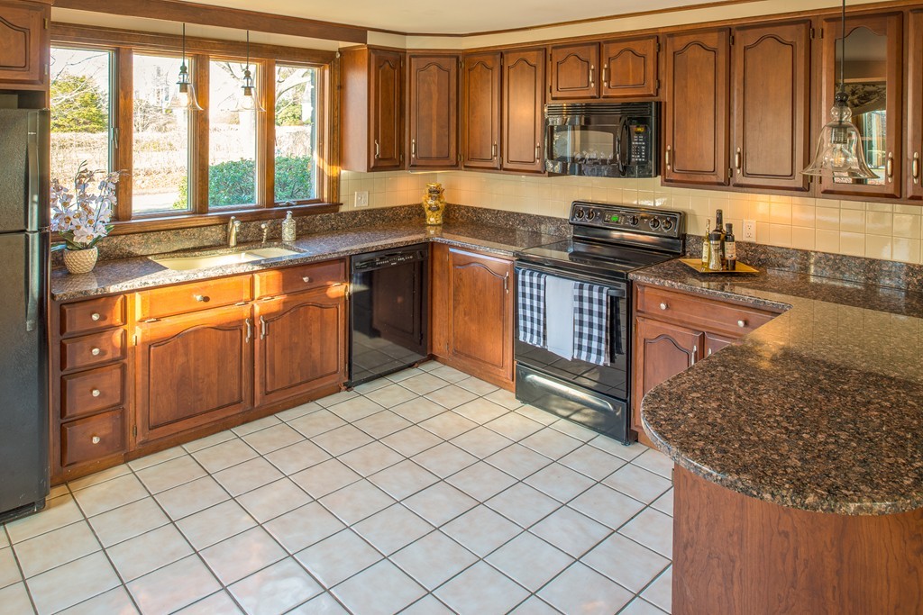 43 Shorewood Road Marblehead, MA 01945 - Photo 9 of 30 a kitchen with stainless steel appliances granite countertop a sink stove and cabinets