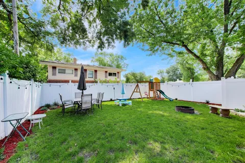 a view of a house with backyard sitting area and garden