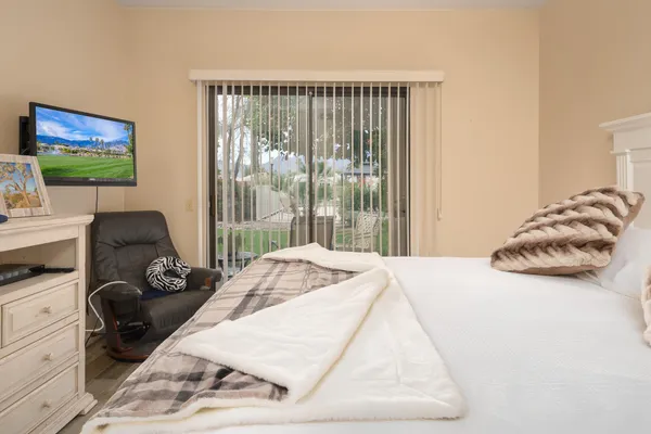 a bedroom with a bed and a flat screen tv