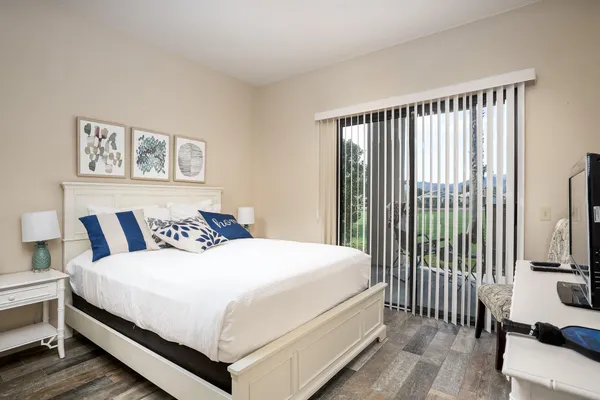 a bedroom with a bed and a flat screen tv