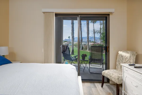 a bedroom with a bed and a lamp next to a window
