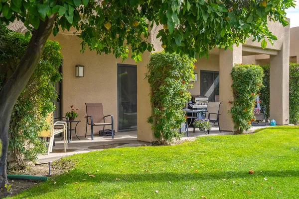 a view of house with backyard and a patio