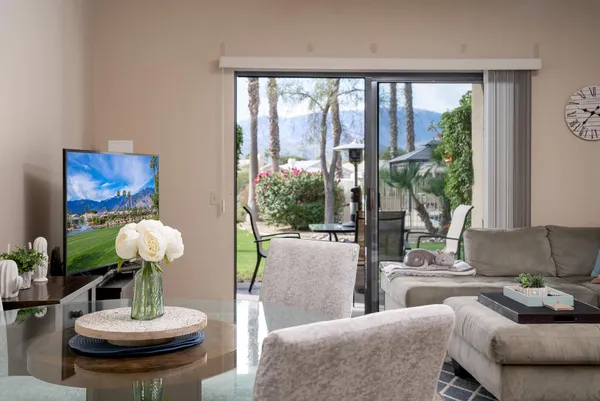a living room with furniture and a large mirror