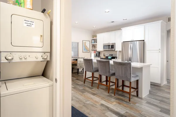 a living room with stainless steel appliances furniture and a table