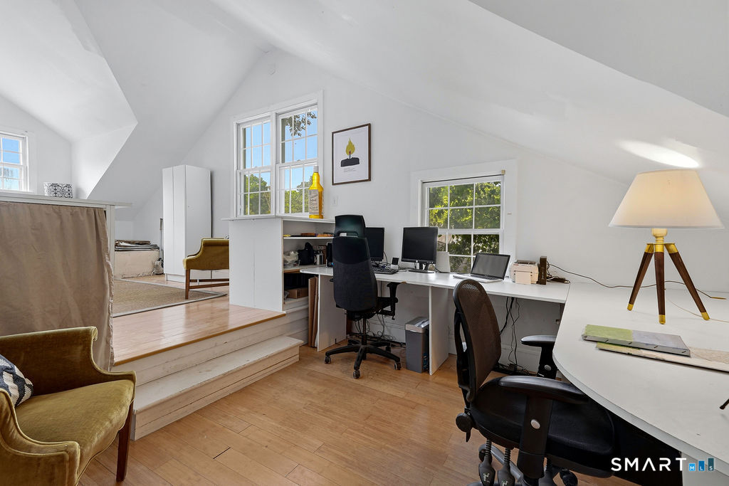 261-1 Grassy Hill Road Lyme, CT 06371 - Photo 27 of 40 Thoughtfully designed and full of architectural interest, the upper-level office provides generous space for work, study, or creative pursuits while overlooking the library below.