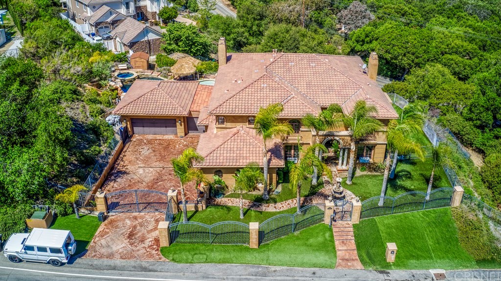an aerial view of residential houses with outdoor space and trees