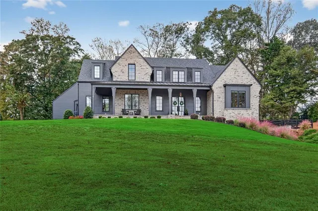 a front view of a house with a garden and porch