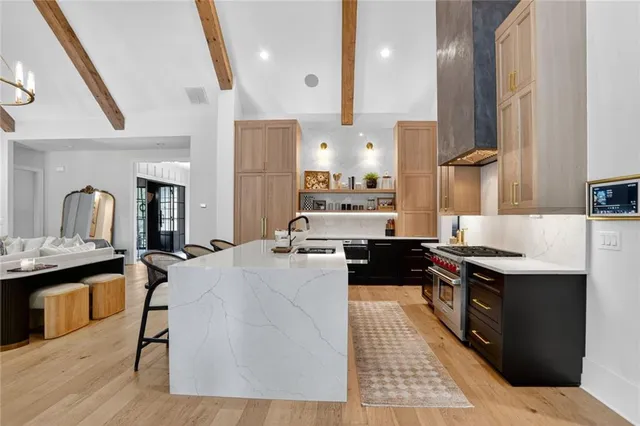a kitchen with stainless steel appliances a sink stove and cabinets