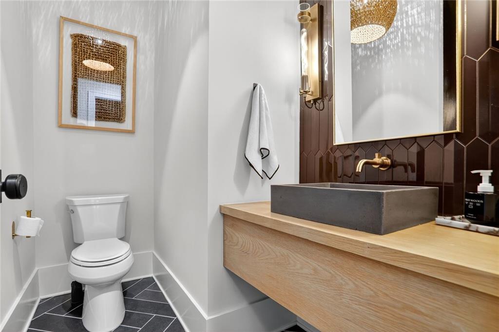 1510 Batesville Road Canton, GA 30115 - Photo 15 of 68 a bathroom with a toilet sink and mirror