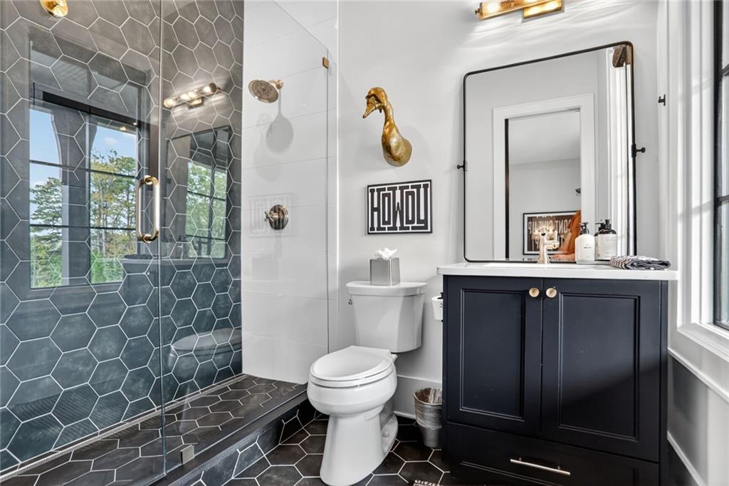 1510 Batesville Road Canton, GA 30115 - Photo 30 of 68 a bathroom with a toilet sink vanity and mirror