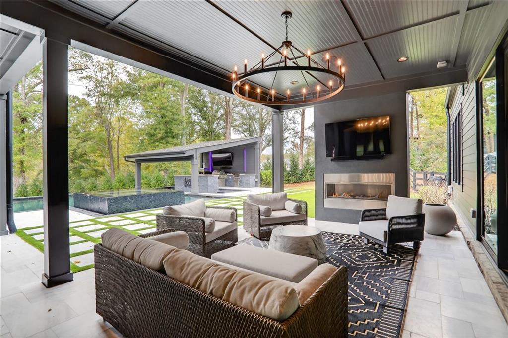 1510 Batesville Road Canton, GA 30115 - Photo 40 of 68 a living room with furniture a flat screen tv and a large window