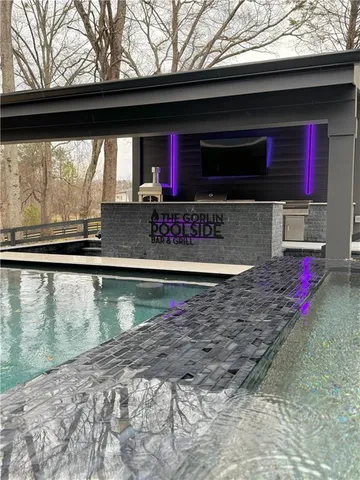 a view of a house with swimming pool and sitting area