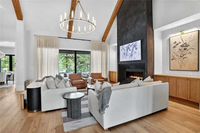 a living room with furniture a fireplace and flat screen tv