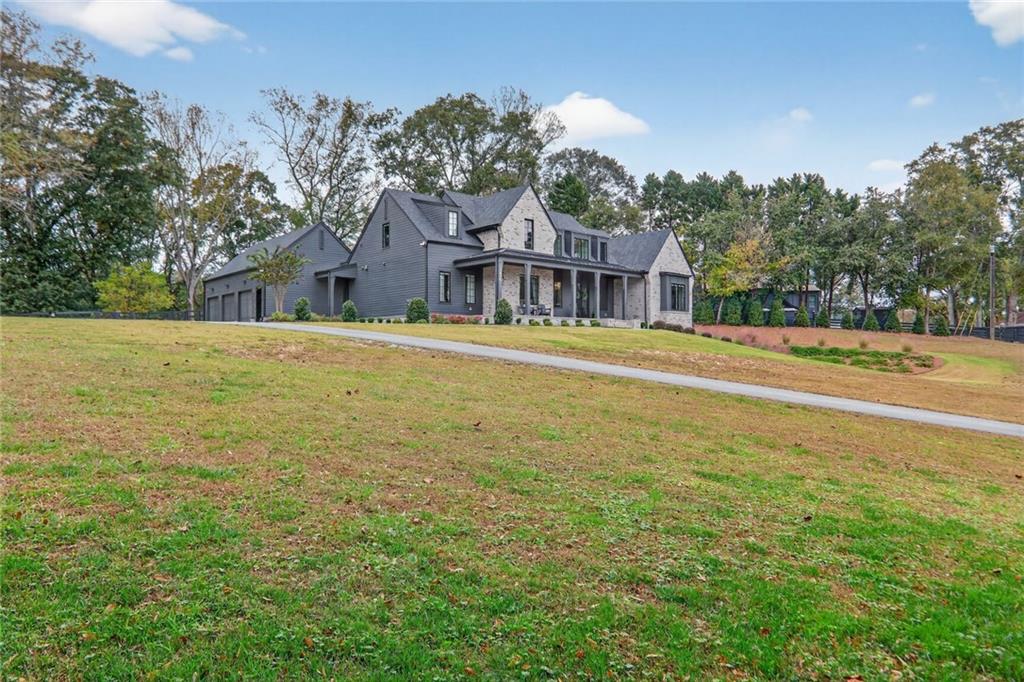 1510 Batesville Road Canton, GA 30115 - Photo 55 of 68 a front view of house with yard and trees in the background