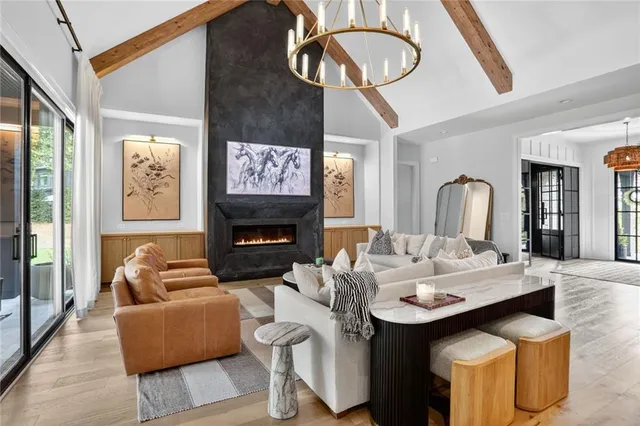 a living room with furniture a large window and a flat screen tv