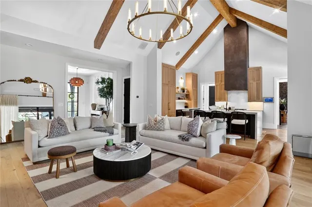 a kitchen with stainless steel appliances a stove a sink dishwasher a oven with a dining table and chairs