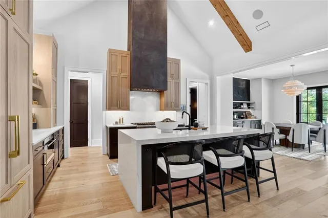 a kitchen with a sink chairs and refrigerator