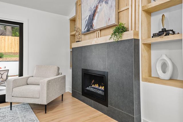 a dining room with stainless steel appliances kitchen island granite countertop furniture and a wooden floor