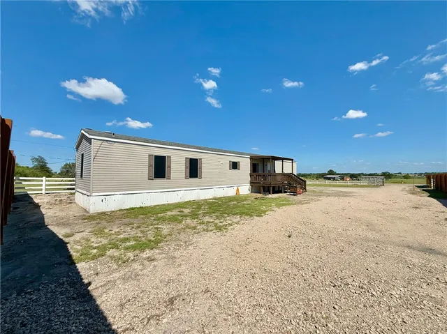 a view of a house with a backyard