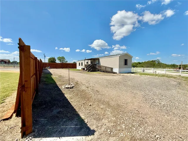 a view of a balcony with a floor to ceiling window and an outdoor kitchen