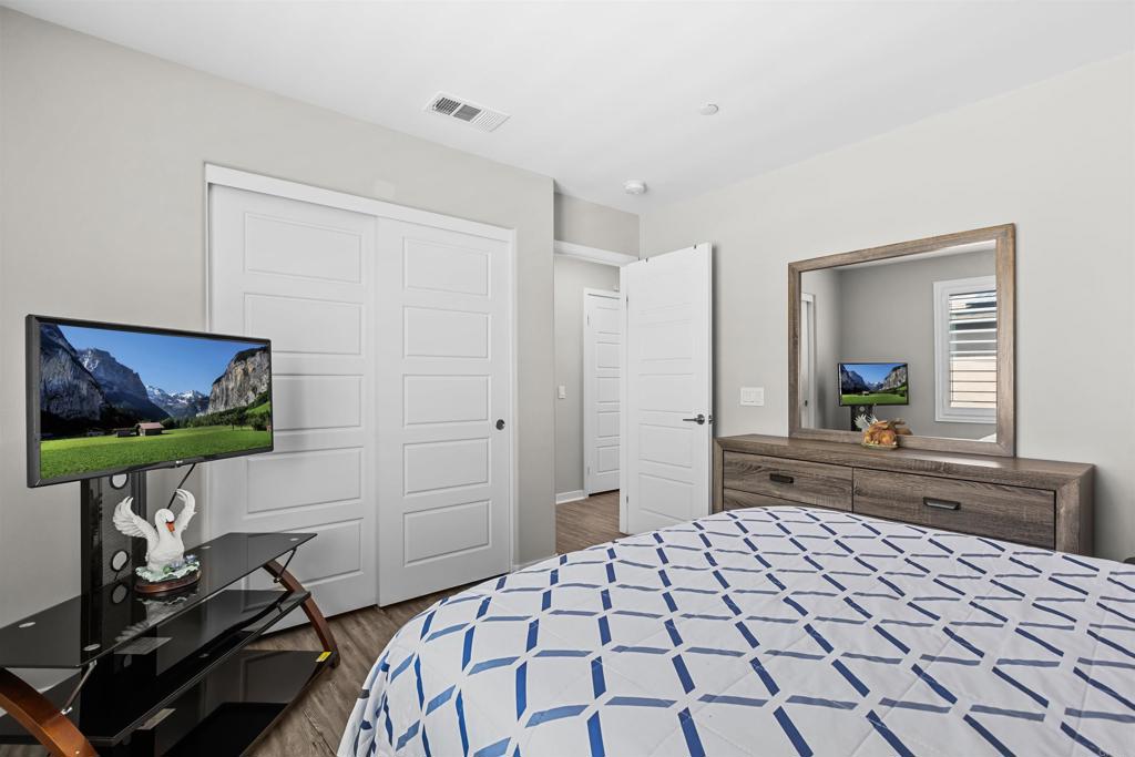 29809 Gypsy Vanner Way Menifee, CA 92584 - Photo 28 of 45 a bedroom with a bed and a flat screen tv