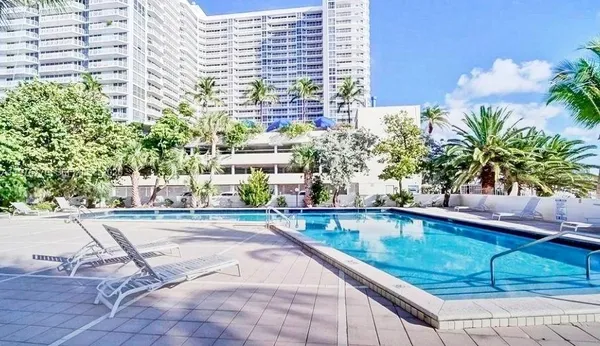a swimming pool with outdoor seating and yard