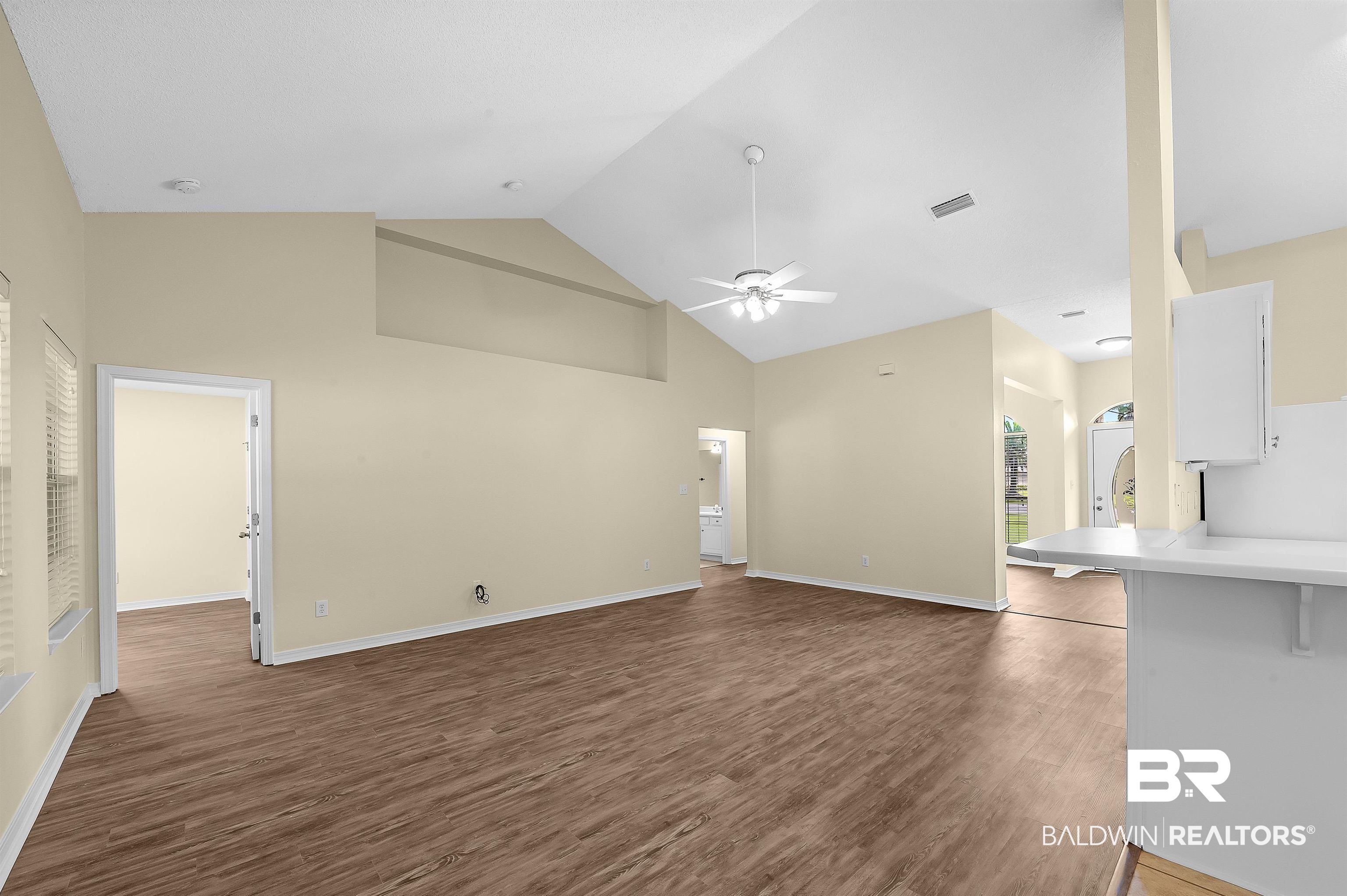 12443 Venice Boulevard Foley, AL 36535 - Photo 27 of 59 Unfurnished living room featuring high vaulted ceiling, hardwood / wood-style floors, and ceiling fan
